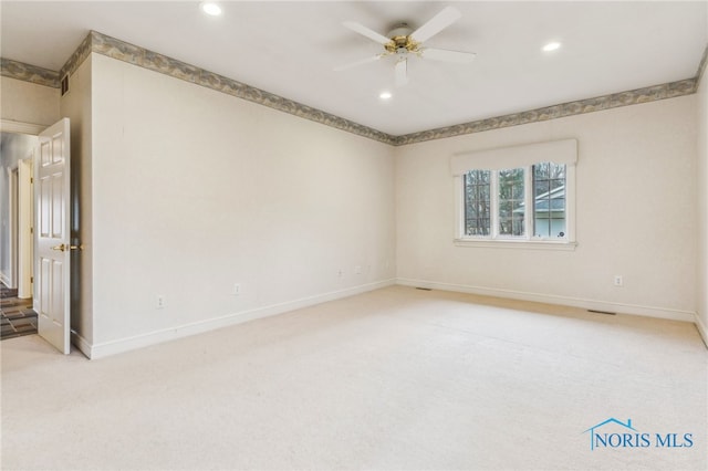 carpeted empty room featuring ceiling fan