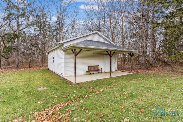 view of outbuilding with a yard