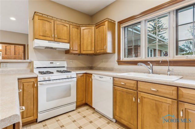 kitchen featuring sink and white appliances