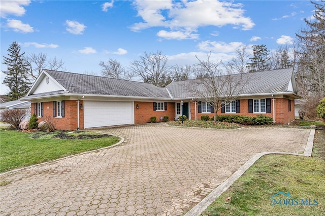 ranch-style house with a front yard and a garage