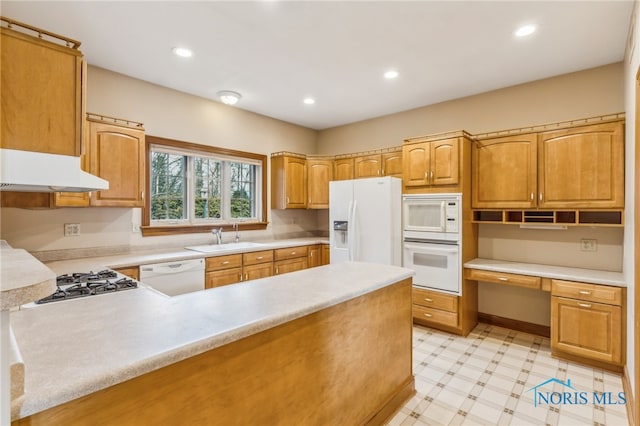 kitchen with sink, exhaust hood, kitchen peninsula, white appliances, and built in desk