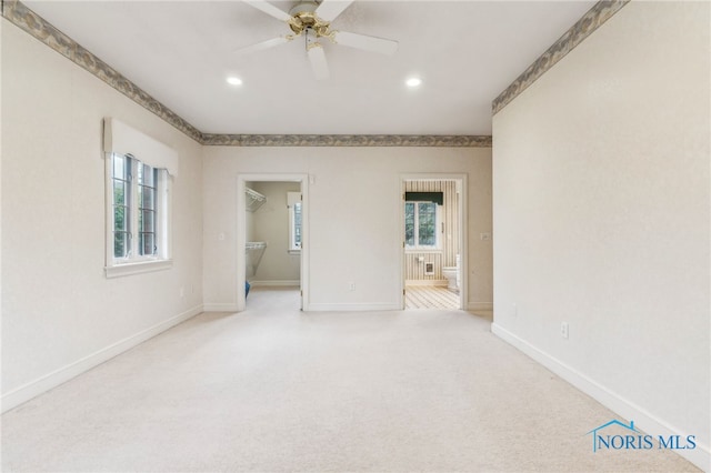 unfurnished room with ceiling fan and light colored carpet