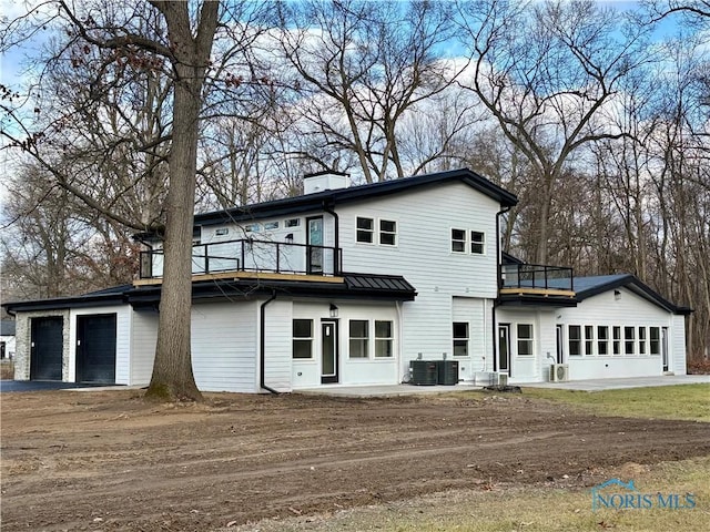 rear view of property with a balcony and cooling unit