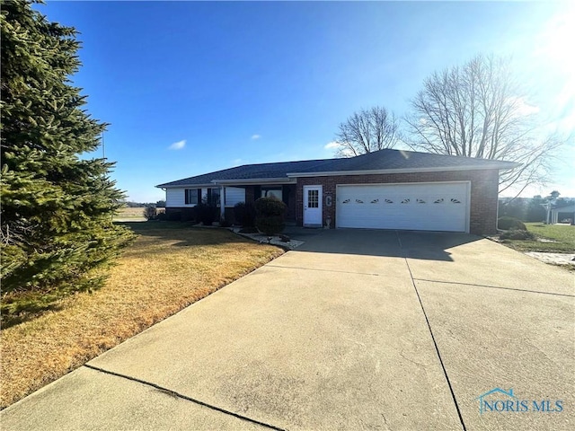 single story home featuring a garage and a front yard