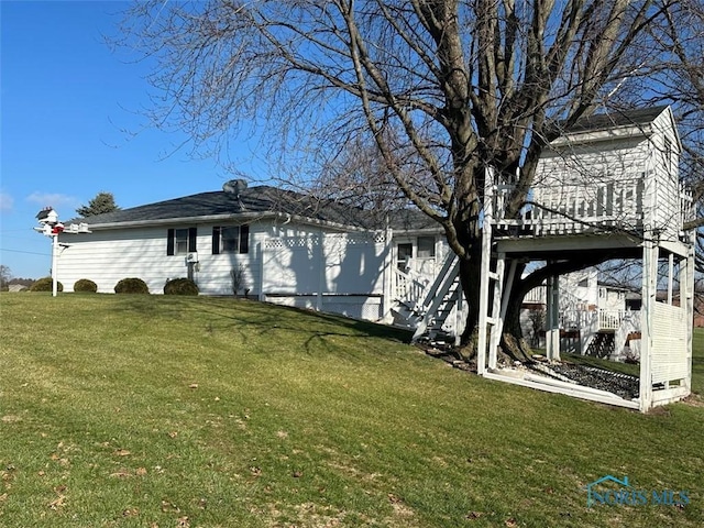 back of house with a yard and a deck