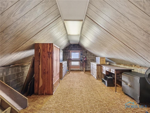 interior space with wooden walls, light colored carpet, and lofted ceiling