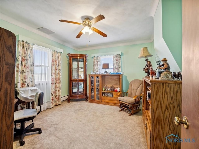 carpeted home office featuring ceiling fan and a baseboard radiator