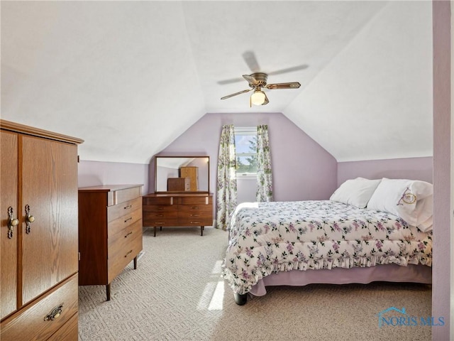 carpeted bedroom featuring ceiling fan and vaulted ceiling