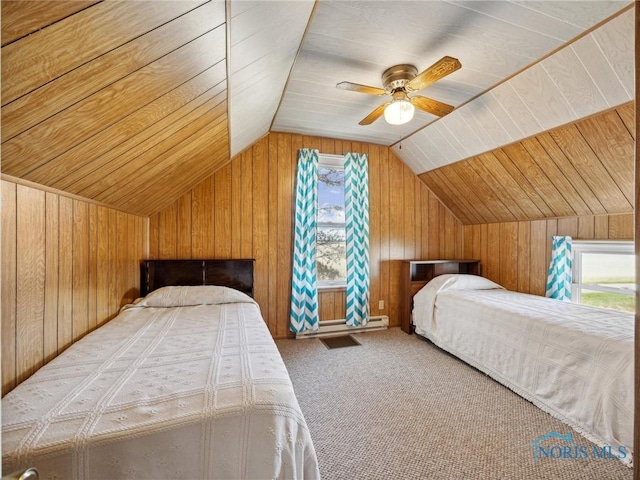 carpeted bedroom with multiple windows, vaulted ceiling, ceiling fan, and wooden walls