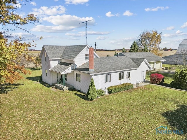 rear view of house with a lawn