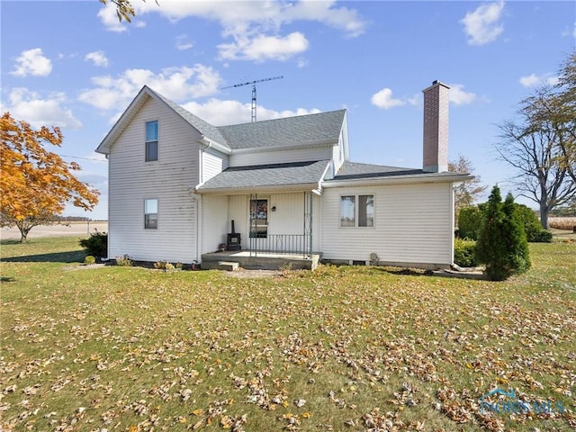 rear view of property with a lawn and a porch