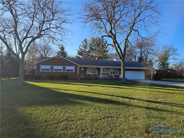 single story home with a front yard, a porch, and a garage