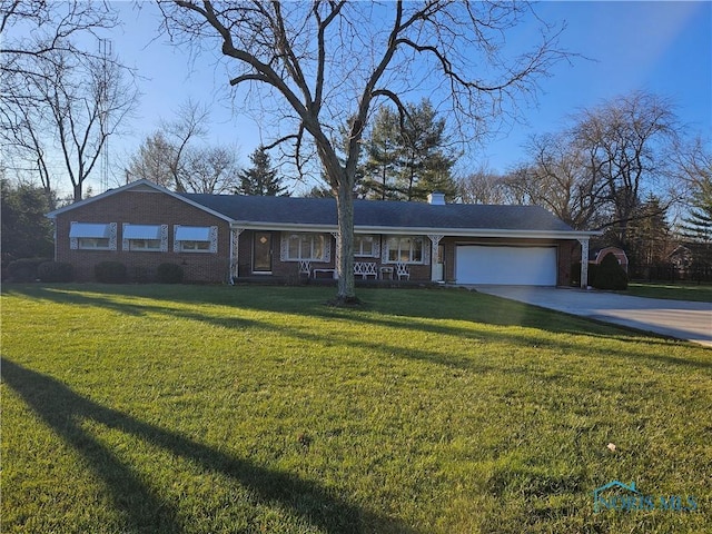 single story home with a garage and a front lawn