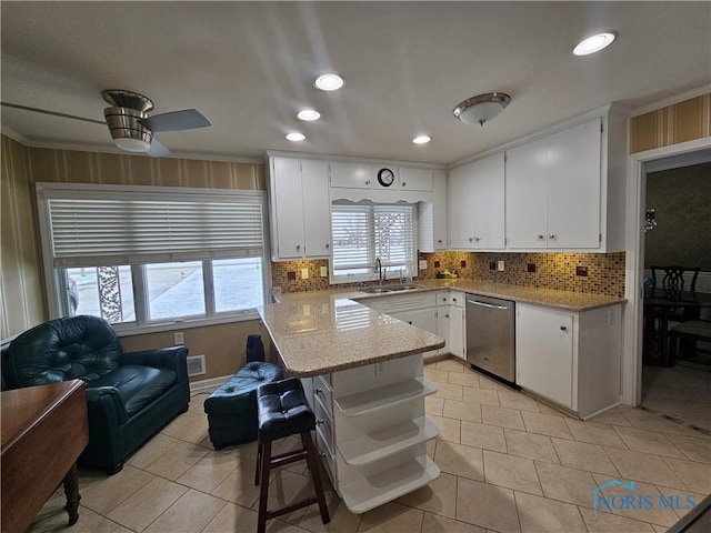 kitchen with white cabinets, sink, stainless steel dishwasher, ceiling fan, and light tile patterned floors