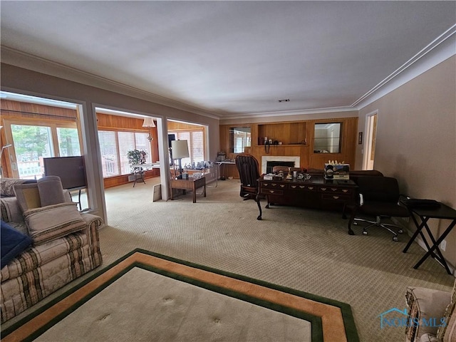 carpeted living room featuring crown molding and a tiled fireplace