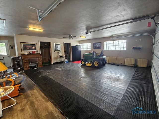 garage featuring a garage door opener and ceiling fan