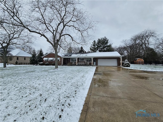 ranch-style house with covered porch and a garage