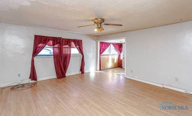 unfurnished room featuring ceiling fan and light hardwood / wood-style flooring