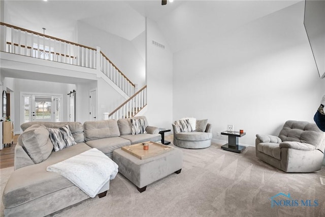 living room featuring high vaulted ceiling and wood-type flooring