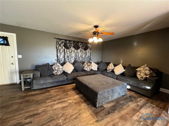 living room with dark hardwood / wood-style floors and ceiling fan