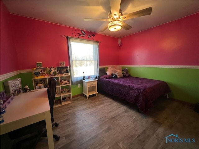 bedroom featuring hardwood / wood-style flooring and ceiling fan