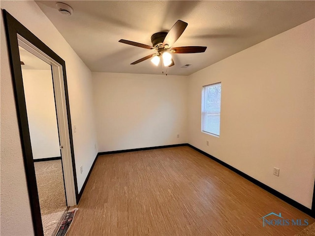 unfurnished room featuring ceiling fan and wood-type flooring