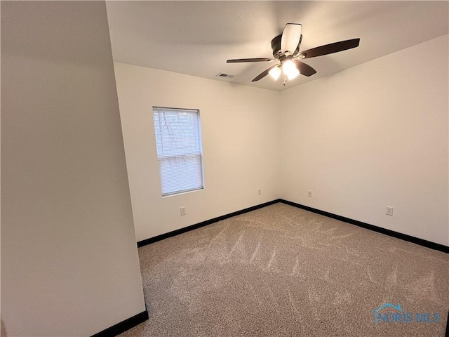 unfurnished room featuring carpet and ceiling fan