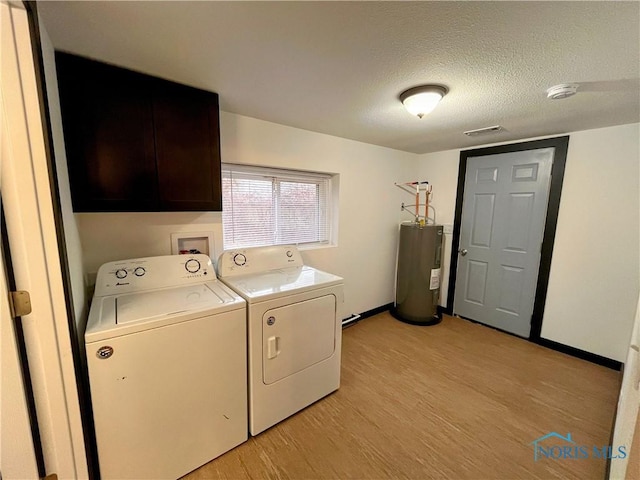 laundry area with cabinets, independent washer and dryer, a textured ceiling, water heater, and light hardwood / wood-style floors