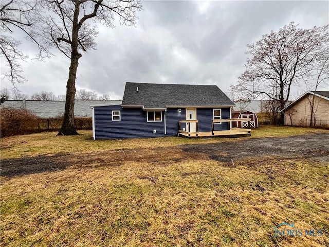 back of house with a yard and a wooden deck