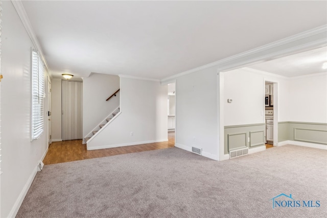 carpeted spare room with crown molding