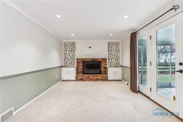 unfurnished living room with a fireplace, light colored carpet, plenty of natural light, and ornamental molding