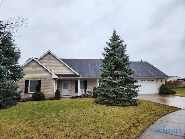 single story home featuring covered porch, a garage, and a front yard