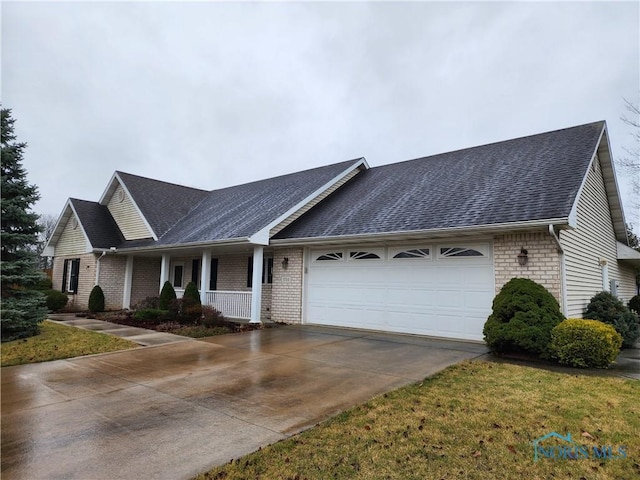 single story home with covered porch and a garage