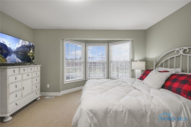 bedroom featuring light colored carpet