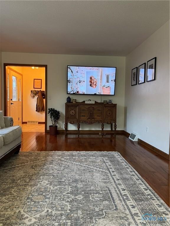 living room with dark hardwood / wood-style flooring