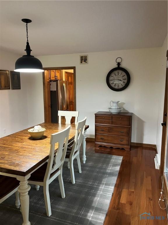 dining room with dark hardwood / wood-style flooring