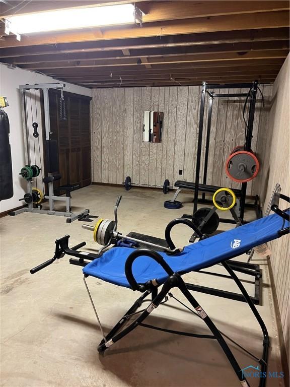 workout room featuring wood walls