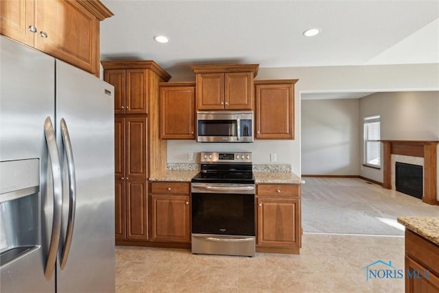 kitchen with stainless steel appliances and light stone counters