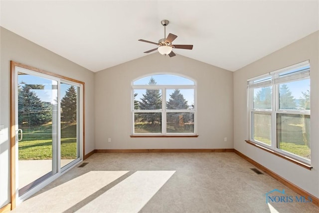 carpeted empty room featuring ceiling fan and vaulted ceiling