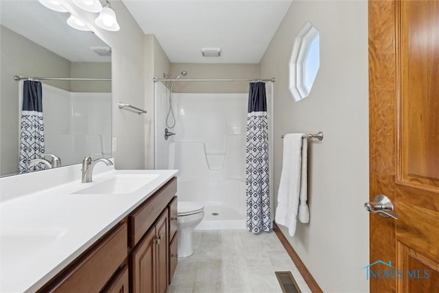 bathroom with vanity, toilet, and walk in shower