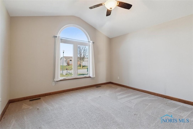 unfurnished room featuring ceiling fan, carpet floors, and lofted ceiling