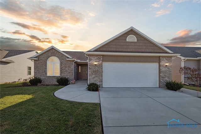 ranch-style house with a yard and a garage