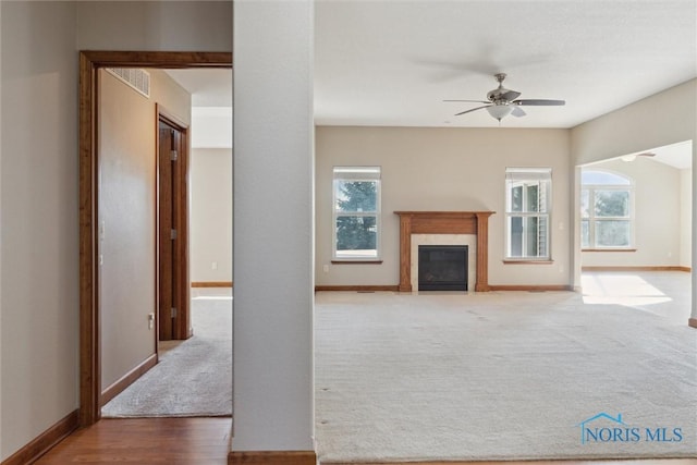 unfurnished living room with ceiling fan