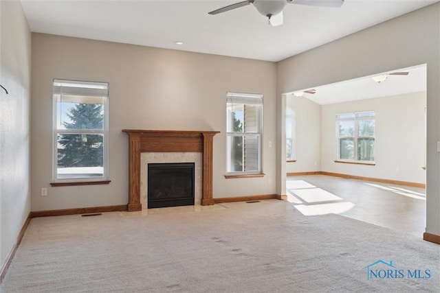 unfurnished living room featuring light colored carpet and ceiling fan