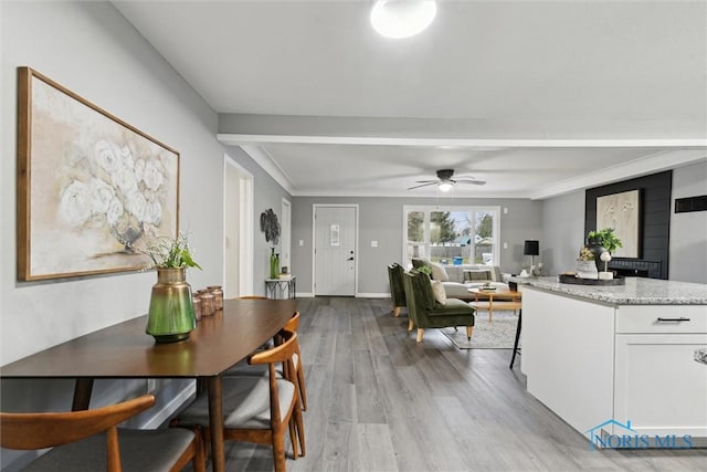 dining room featuring ceiling fan, light wood-type flooring, and ornamental molding