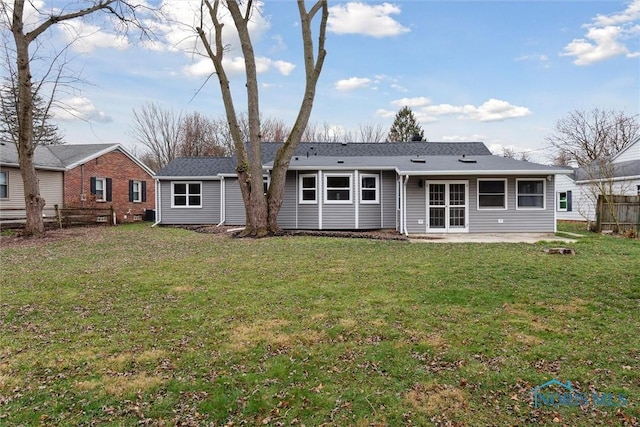 rear view of house with a yard and a patio area