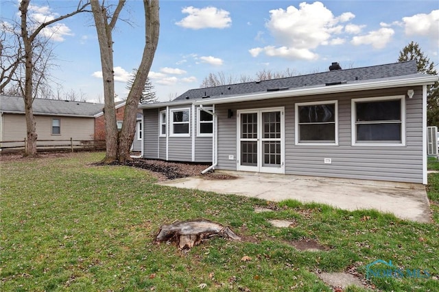 rear view of property with a yard and a patio