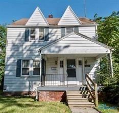 view of front of home with covered porch and a front yard