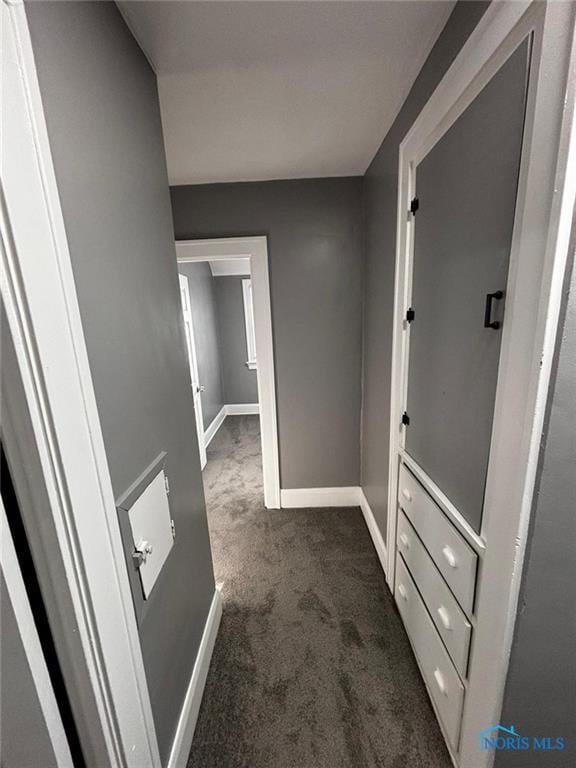 hallway with dark colored carpet