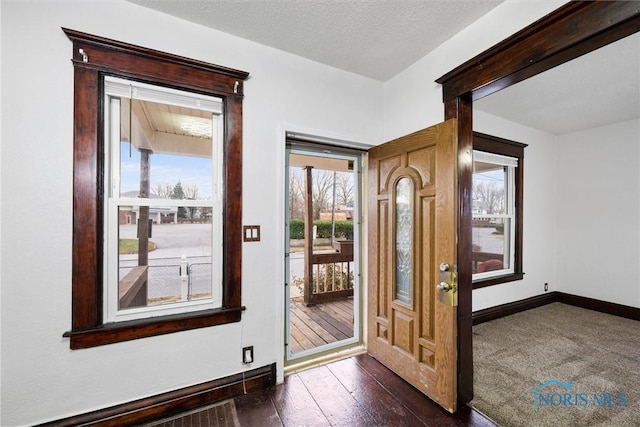 entrance foyer featuring dark hardwood / wood-style flooring and a textured ceiling